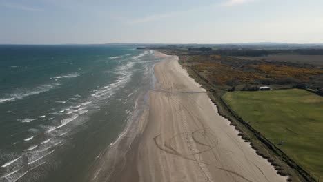 Drone-shot-of-a-sunny-beach-in-Meath,-Ireland