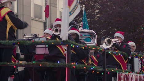 Instrumental-band-plays-on-a-float-while-conductor-directs-them-in-Christmas-parade