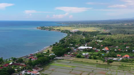 beautiful-wide-panoramic-of-Lovina-coastline-on-sunny-day-in-north-Bali,-aerial