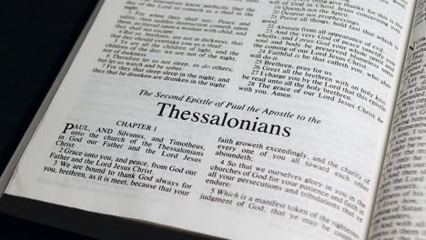 Close-Up-Shot-of-Bible-Page-Turning-to-the-book-of-Second-Thessalonians