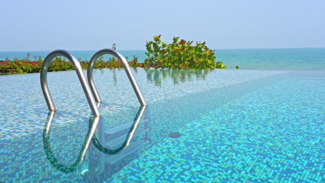 Seafront-infinity-pool-entrance-with-metal-handrails