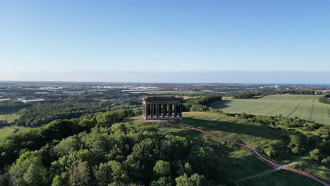 Aerial-wide-cinematic,-camera-pulls-back-and-rises-up-on-Penshaw-Monument-in-Sunderland,-North-East,-UK