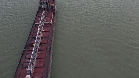 Long-industrial-cargo-vessel-shipping-on-Detroit-river,-aerial-fly-over-view
