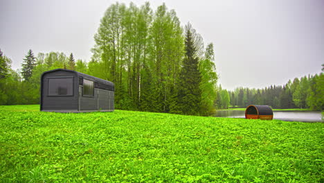 Thermal-Wood-Cabin-With-Thermowood-Barrel-Sauna-On-Greenery-Landscape-During-Misty-Sunrise