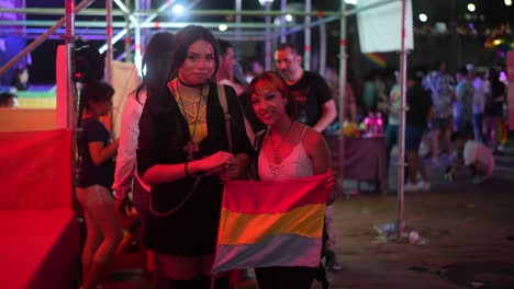 Two-beautiful-girls-are-seen-enjoying-in-the-LGBT-Pride-Parade-at-night