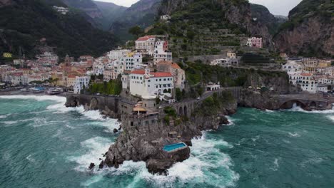 Swimming-Pool-by-Ocean-Cliffs-on-Amalfi-Coast,-Amalfi,-Italy---Aerial