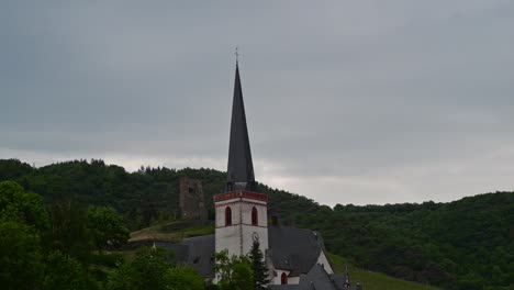 Time-lapse-of-a-thick-cloud-cover-above-a-catholic-church-in-Klotten,-Germany