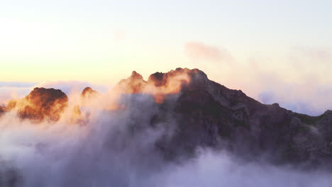 Mountain-peak-shrouded-in-clouds-during-the-magic-hour