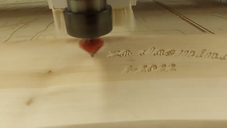 CNC-Router-machine-carving-out-some-text-on-wooden-plank