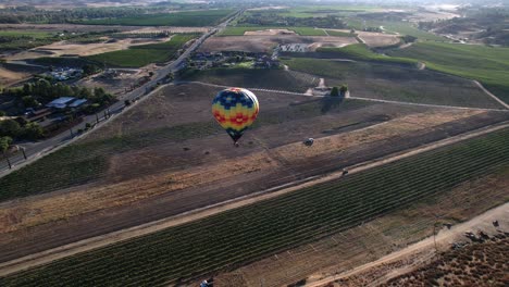 Aerial-view-of-a-hot-air-balloon-flying-over-Temecula-in-California,-America