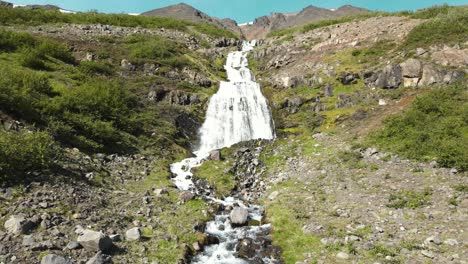 Einen-Wasserfall-Hinauffliegen,-Mit-Bergen-Im-Hintergrund