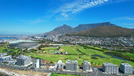 Sunny-day-in-Green-Point,-Cape-Town-with-coastline-view-of-golf-course-and-stadium,-aerial