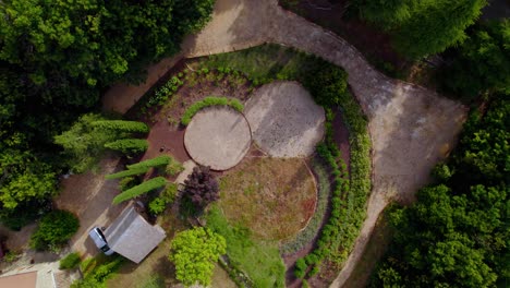 Villa-garden-with-walking-path-in-southern-France,-Aerial-top-view-rising-shot