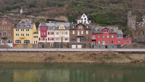 sliding-drone-footage-flying-over-the-river-Moselle-with-a-view-of-the-typical-houses-on-the-riverbanks-of-the-city-of-Cochem-in-Germany