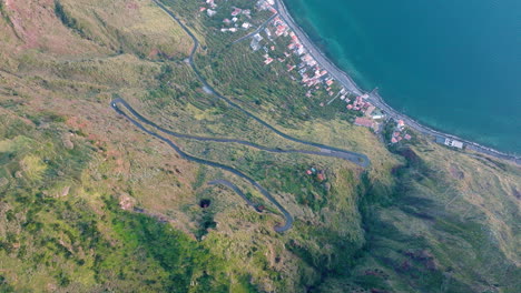 Scenic-and-winding-coastal-road-leading-down-to-Paul-do-Mar,-Madeira