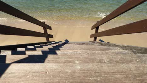 Tight-shot-of-looking-down-the-steps-to-shallow-water-and-a-clean-sandy-beach