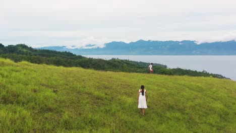 People-Walking-Across-The-Rolling-Hills-In-Tomas-Oppus,-Southern-Leyte,-Philippines