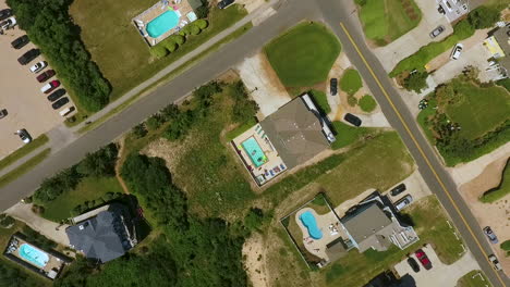 Rising-and-rotating-drone-shot-of-beach-homes-with-swimming-pools