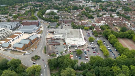 Reversing-aerial-shot-of-Kingsmead-Street,-showing-Sainsbury's-and-the-Riverside-development