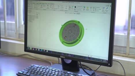 Computer-engineer-animating-a-3d-model-of-metal-object-in-desktop-computer