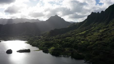 Dolly-aerial-shot-of-an-ancient-fishpond-and-coastal-mountain-ridge-on-the-island-of-O'ahu,-Hawaii