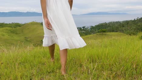 Female-In-White-Dress-Walking-Barefooted-On-The-Hills