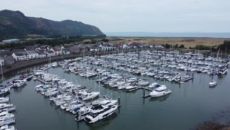 Aerial-view-Wealthy-luxury-yachts-and-sailing-boats-moored-in-quaint-Conwy-town-marina