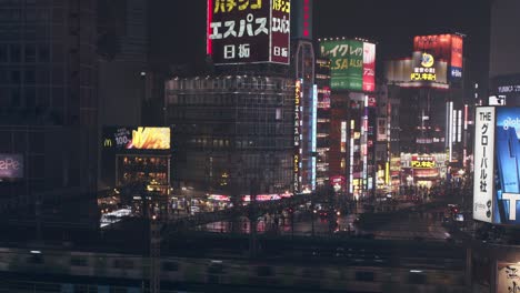 Night-static-shot-of-Shinjuku,-Tokyo-near-the-train-station-during-the-night