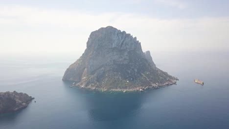 Aerial-shot-of-scenic-rocky-mountain-Es-Vedra-Island-in-the-blue-sea-in-Ibiza