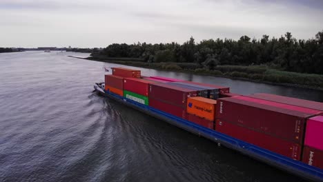 Aerial-Flying-Past-Levante-Cargo-Container-Transport-Ship-Along-Oude-Maas-On-Cloudy-Day