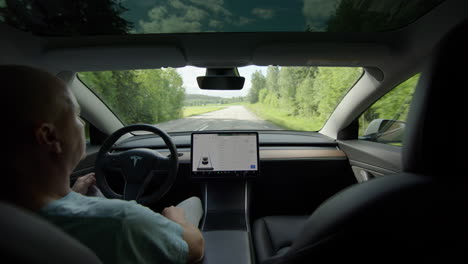 Driving-a-level-2-autonomous-Tesla-Model-3-on-a-countryside-main-road
