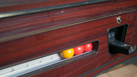 Pool-balls-entering-a-coin-oporated-pool-table-return-rack-system