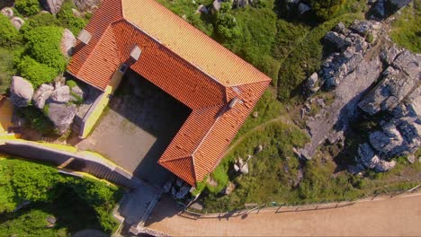Aerial-view-over-pilgrims-house-of-Capela-de-Nossa-Senhora-da-Peninha-chapel,-in-Sintra,-Portugal---orbit,-drone-shot