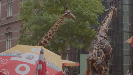 Streetperformer-dressed-as-giraffe-walking-around