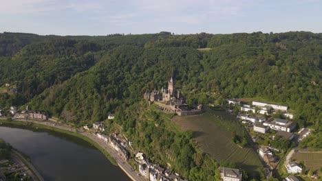 Aerial-Arcing-Shot-Of-The-Stunning-Cochem-Castle-Alongside-Moselle-River