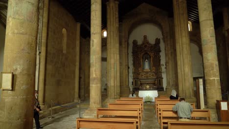 Panoramic-View-of-São-Tiago-church-in-Coimbra-with-Praying-People