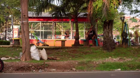 Un-Hombre-Sentado-En-El-Asiento-En-El-Parque-De-La-Ciudad,-Semarang,-Java-Central,-Indonesia-El-10-De-Junio-De-2022