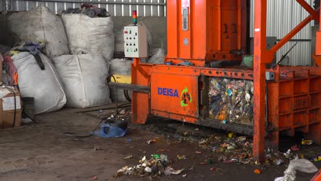 Static-view-of-a-waste-compactor-machine-with-a-yellow-light-flashing