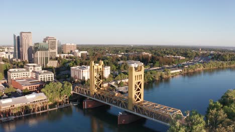 Panning-aerial-shot-of-the-Tower-Bridge-with-Downtown-Sacramento-in-the-background