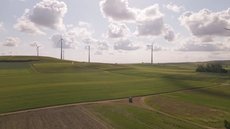Wind-park-in-the-fields-of-Rhineland-palatinate,-Germany-underneath-a-bright-blue-sky-with-soft-cumulus-clouds