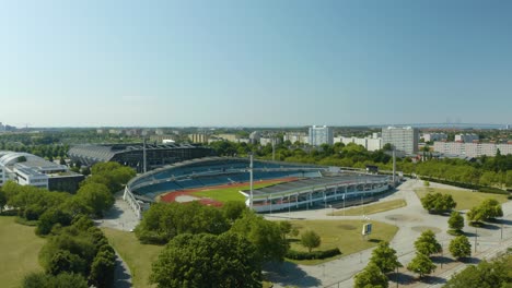 Aerial-Boom-Shot-Reveals-Eleda-Stadium-and-Running-Track-on-Beautiful-Summer-Day