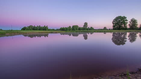 Ruhige,-Farbenfrohe-Sonnenaufgangsreflexionen-Des-Himmels-In-Einem-See-Mit-Stillem-Wasser