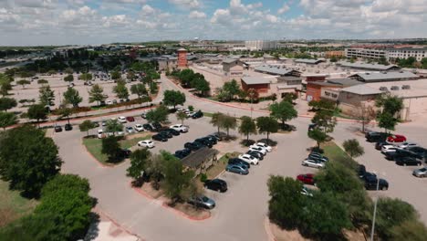 Round-Rock-Premium-Outlets-aerial-push-in-above-parking-lot-and-retail-shops-in-4k-Texas