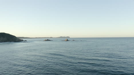 4k-Drone-shot-moving-towards-a-lonely-island-outside-Byron-Bay,-Australia