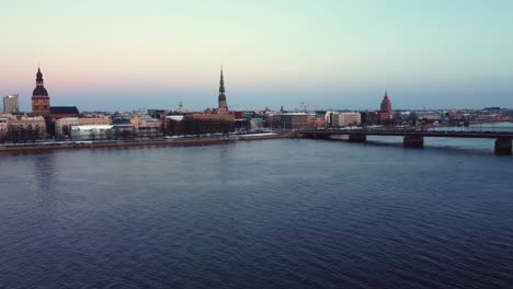 Establisher-aerial-view-of-Daugava-river-in-Riga-city-center,-winter-season