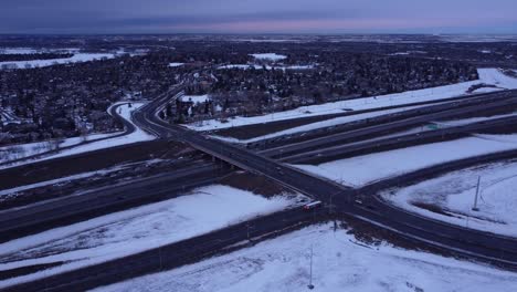 Winter-sunset-aerial-drone-footage-of-snowy-roads-and-traffic-jams
