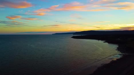 A-high-drone-shot-over-the-Bay-of-Fundy-coastline-near-Waterside-Beach,-New-Brunswick-at-dusk