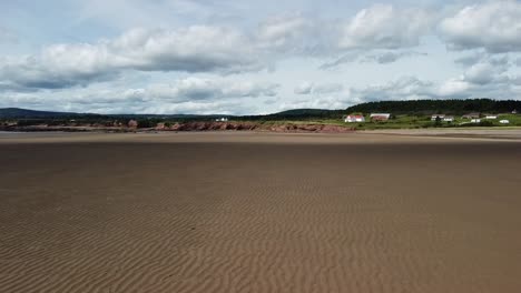 Low-flying-drone-shot-over-Waterside-Beach-heading-towards-shore-by-Bay-of-Fundy,-New-Brunswick