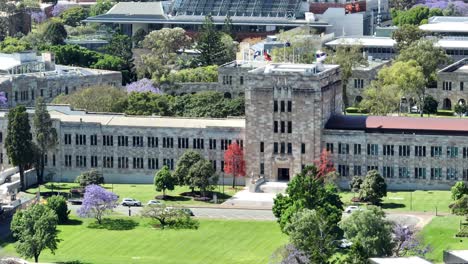Aerial-telephoto-shot-of-UQ's-Great-Court-and-Forgan-Smith-Building,-with-camera-drone-rotating-around-main-building-from-a-large-distance-away