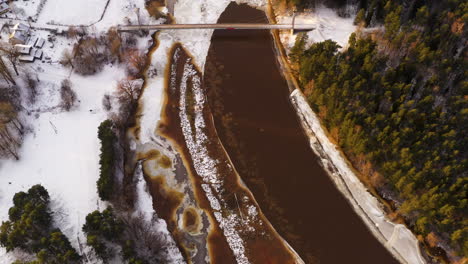 River-Gauja-in-Valmiera,-Latvia-during-Snowy-Winter---Aerial-Drone-View